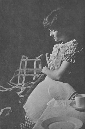 Pioneer craftworks have an individual ingredient of loving care not found in modern assembly-line things.  Debbie Kean of the Foster Museum student staff holds a 100 year old coverlet and linsey blanket, dyed, spun and loomed by Katherine Hillhouse.  Contributed by Mrs. A. E. Seymour and Ruth Clark.